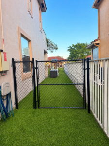 Before and after chain link fence installation in Fort Lauderdale FL by a fence company near me, showing backyard enclosure with black chain link fence in Broward County.